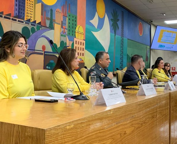 Mesa de debate do Fórum da Juventude na Câmara Municipal de São Paulo, com participantes em destaque.